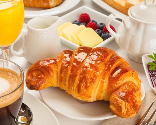 Croissants, jams and juices for breakfast
